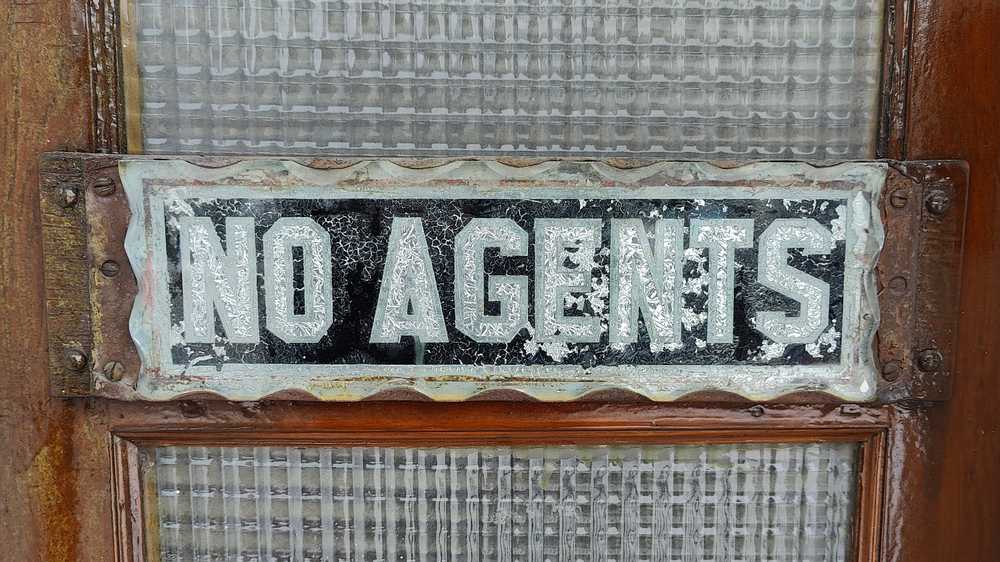 A weathered "No Agents" sign in the exact style of an Edmonton house number plate.