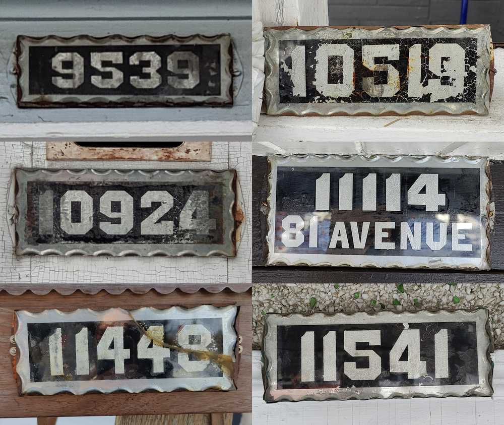Six old house number plates sharing similar characteristics.