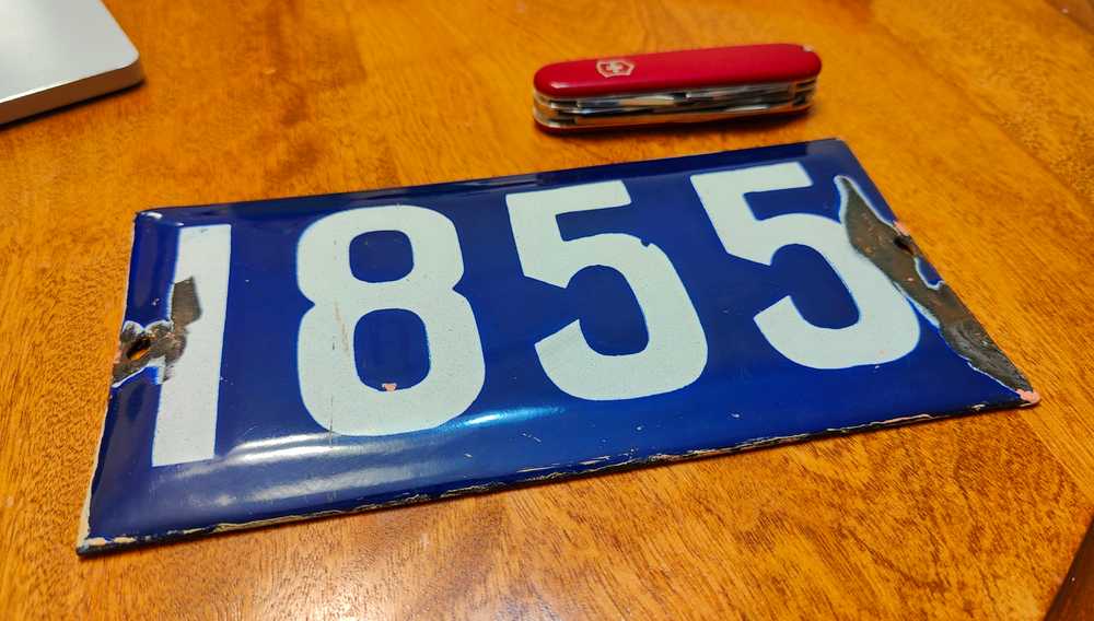 A Regina house number plate separated from its house.