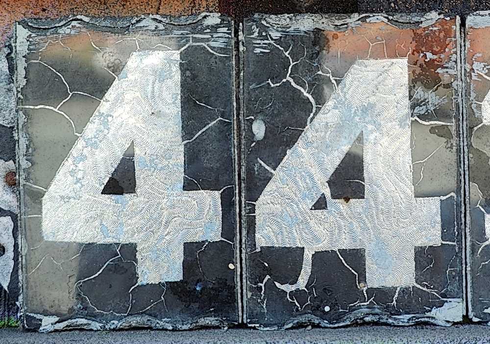 Two hand-cut "4" digits next to each other.