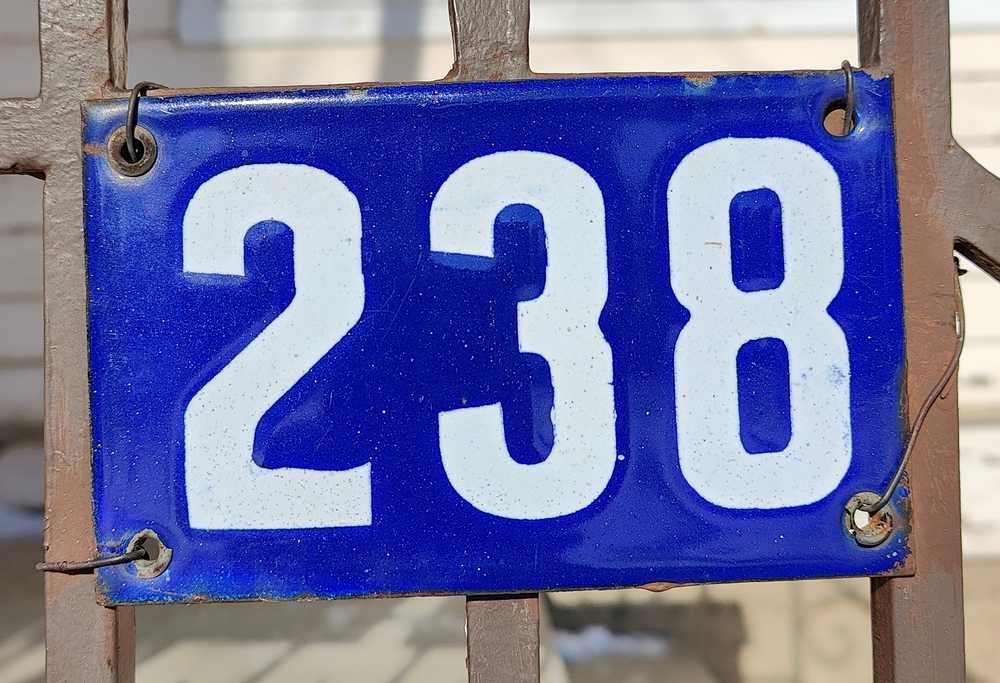 A blue enamel house number plate in Moose Jaw.
