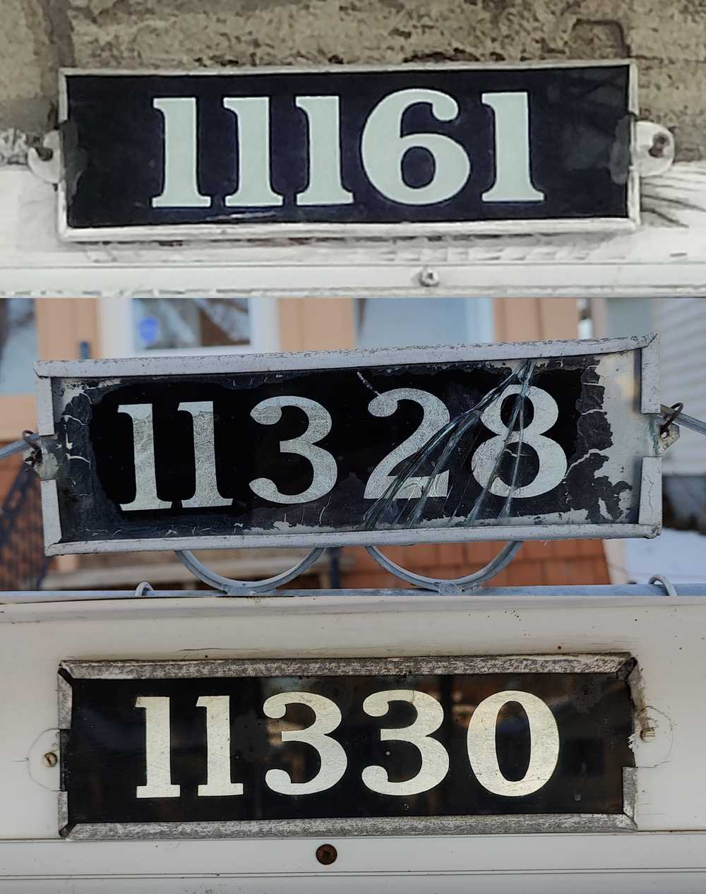 Three old house number plates sharing similar characteristics.