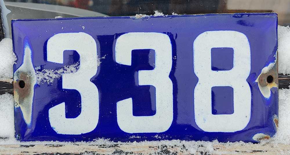 A blue enamel house number plate in Regina.