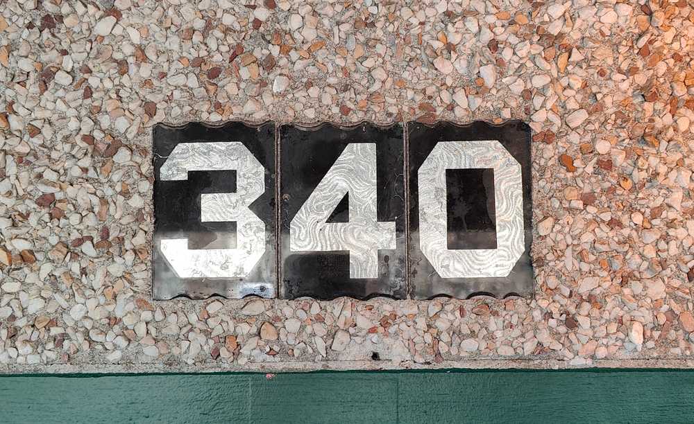 A "340" house number plate in Strathcona, Vancouver.