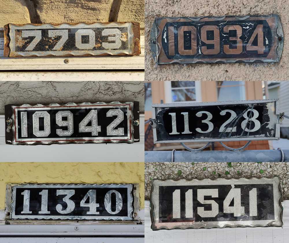 Six old foil-and-glass house number plates in Edmonton.